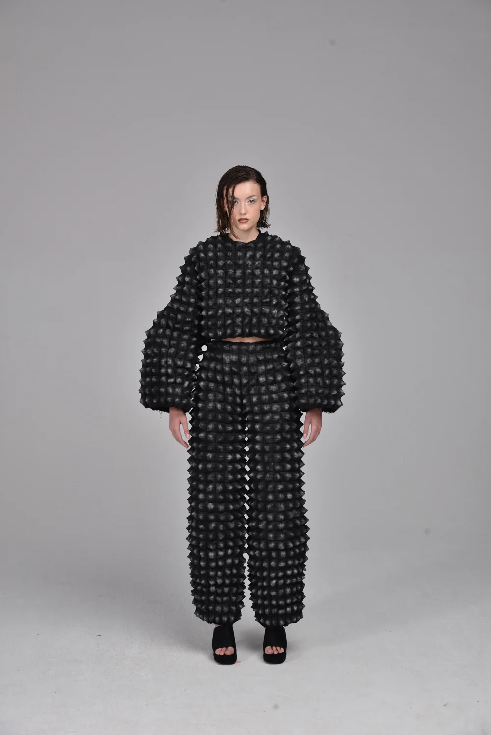 Black sculptural two-piece outfit — design by Iza Bajek